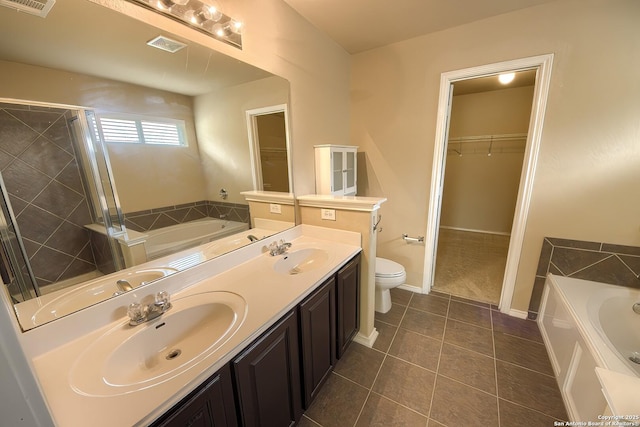 full bathroom with a garden tub, a sink, tile patterned flooring, and a stall shower