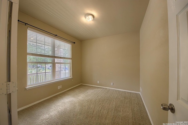 carpeted spare room with baseboards