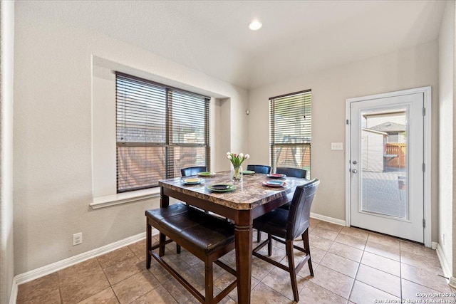 dining room with baseboards and light tile patterned flooring