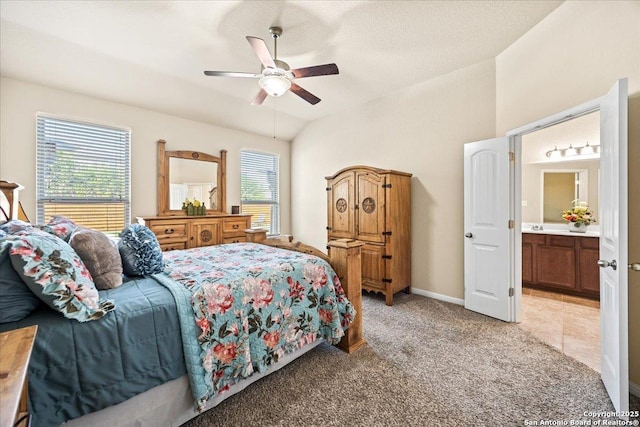 bedroom with connected bathroom, ceiling fan, and light carpet