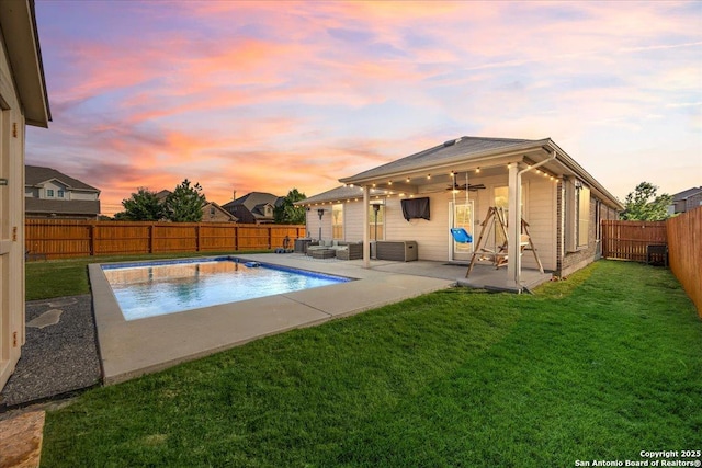 view of pool with ceiling fan, a fenced in pool, a fenced backyard, a lawn, and a patio