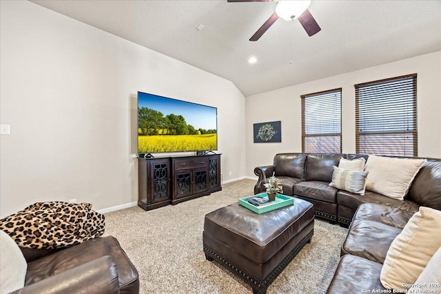 living room with carpet flooring, a ceiling fan, baseboards, and lofted ceiling