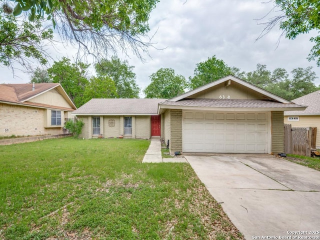 ranch-style house with an attached garage, driveway, roof with shingles, and a front lawn