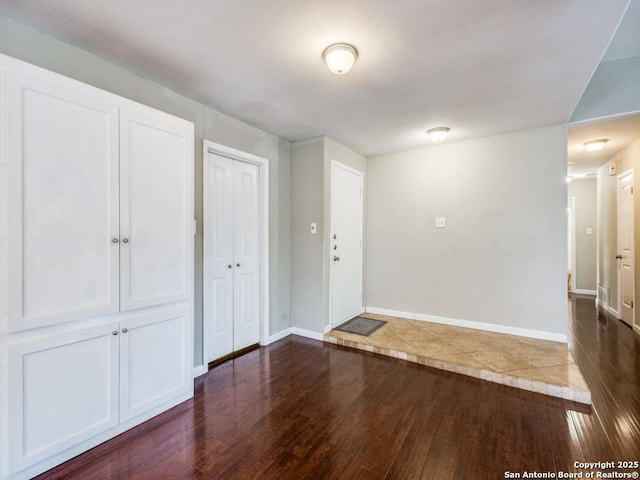 entrance foyer with baseboards and dark wood finished floors