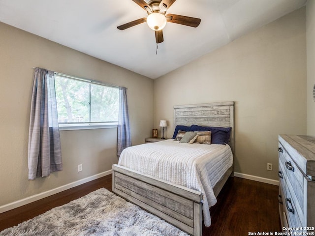 bedroom featuring baseboards, ceiling fan, dark wood-style flooring, and lofted ceiling