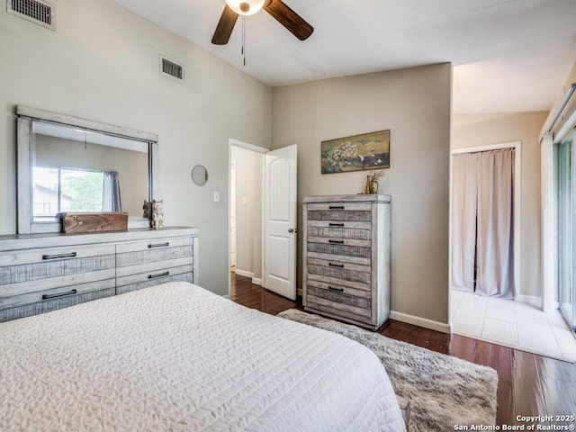 bedroom with visible vents, a ceiling fan, baseboards, and dark wood-style floors