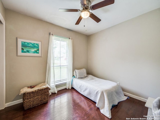 bedroom featuring baseboards, a ceiling fan, and wood finished floors