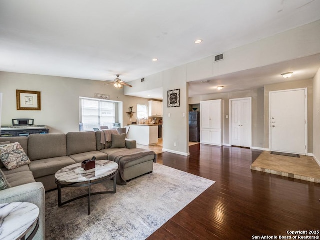 living area featuring recessed lighting, ceiling fan, dark wood finished floors, and baseboards