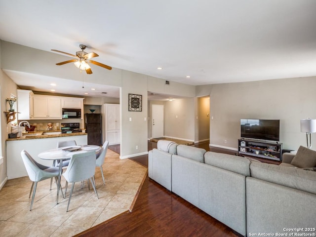 living area featuring recessed lighting, light wood finished floors, ceiling fan, and baseboards