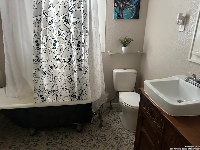 full bathroom featuring vanity, tile patterned flooring, toilet, baseboards, and shower / tub combo