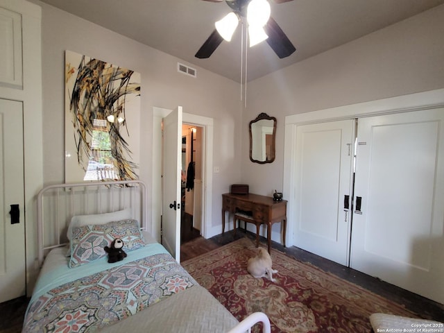 bedroom with visible vents, dark wood-type flooring, a closet, and ceiling fan