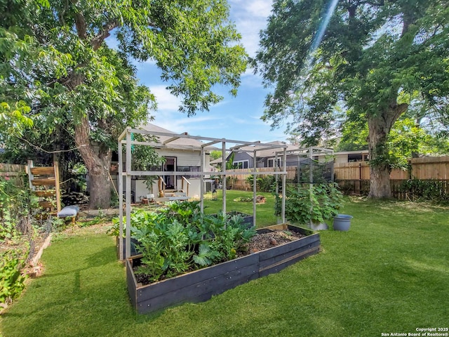 view of yard with a fenced backyard and a vegetable garden