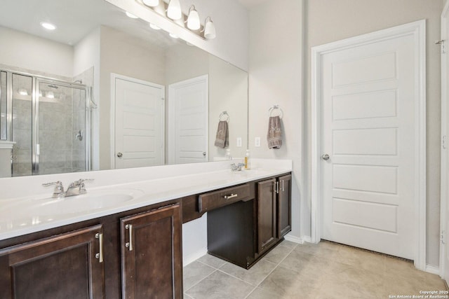 9223 Yaya, Converse, TX 78109 - full bath with double vanity, tile patterned flooring, a stall shower, a sink, and baseboards