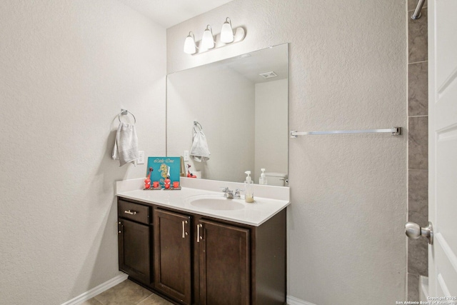 9223 Yaya, Converse, TX 78109 - bathroom featuring vanity, visible vents, a textured wall, baseboards, and tile patterned floors
