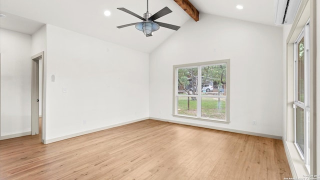 empty room featuring plenty of natural light, baseboards, beam ceiling, and wood finished floors