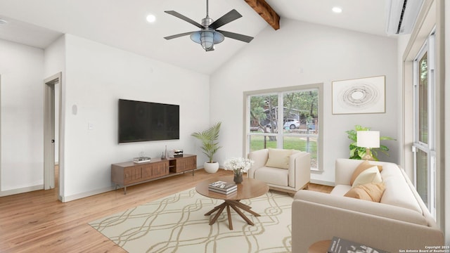 living room with beamed ceiling, plenty of natural light, ceiling fan, and light wood finished floors