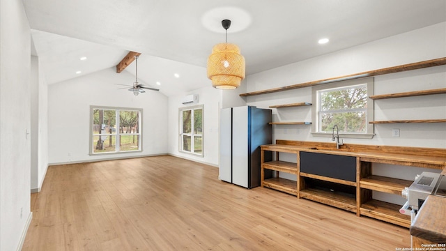 interior space featuring light wood-style floors, lofted ceiling with beams, plenty of natural light, and ceiling fan