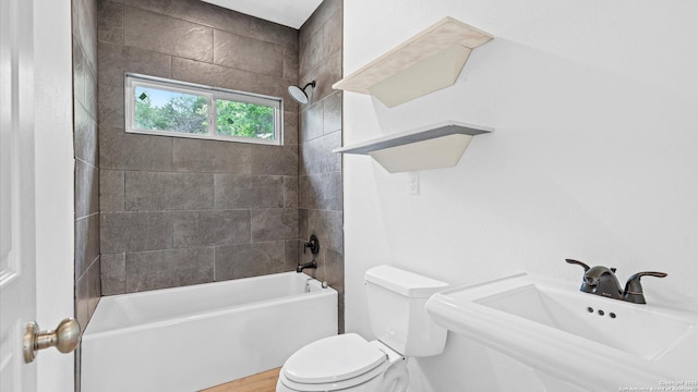 full bathroom with a sink, shower / bathing tub combination, and toilet