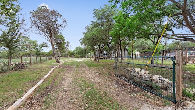 view of street with driveway and a gated entry