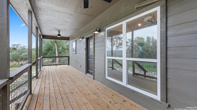 wooden deck featuring a ceiling fan