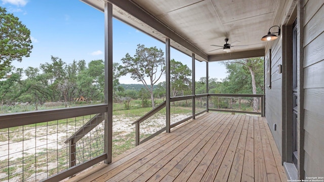 unfurnished sunroom with a ceiling fan