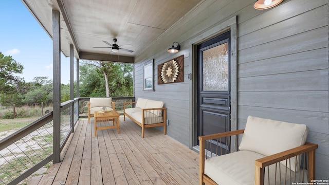 wooden deck featuring a ceiling fan
