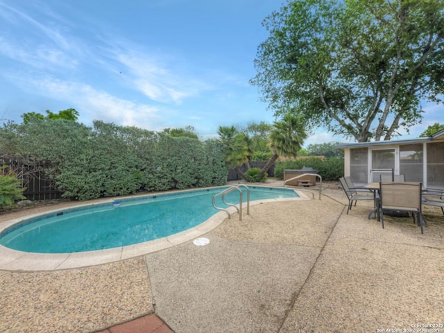 view of pool featuring a fenced in pool, a patio, a sunroom, and outdoor dining space