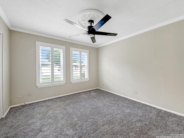 carpeted spare room featuring baseboards, ornamental molding, a textured ceiling, and ceiling fan