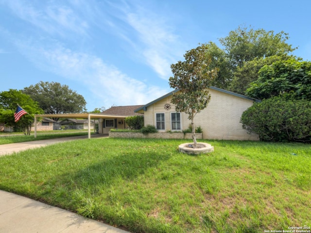single story home featuring an attached carport, a front yard, and concrete driveway