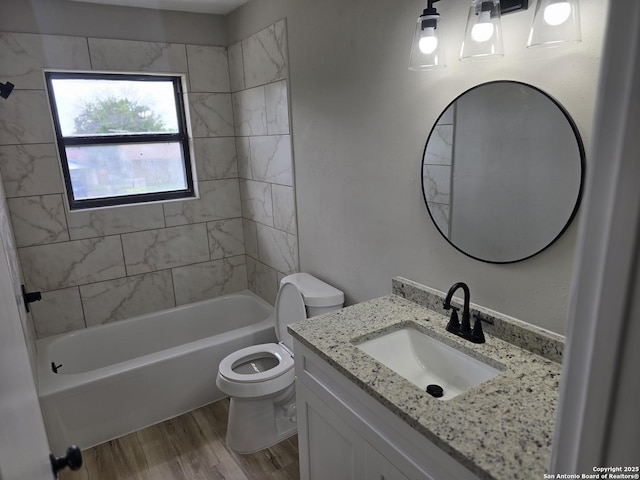 full bath with toilet, shower / washtub combination, wood finished floors, and vanity