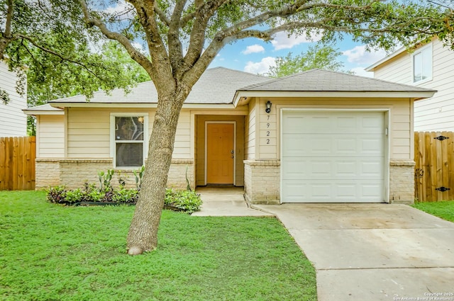 view of front of home with a garage, a front lawn, fence, brick siding, and driveway