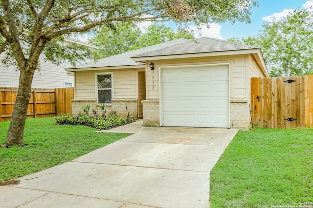 view of front of property with fence, brick siding, a front yard, a gate, and concrete driveway