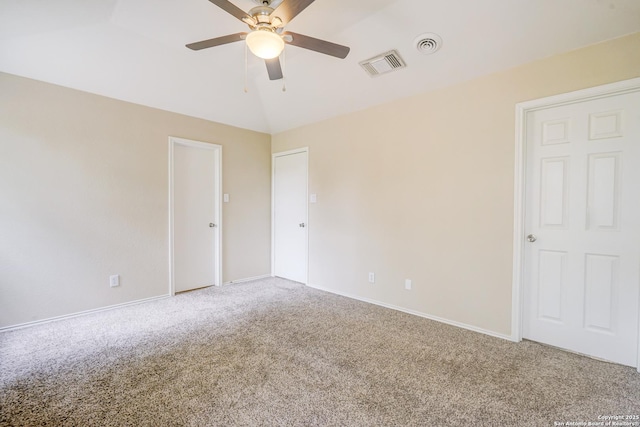 unfurnished room with carpet flooring, ceiling fan, visible vents, and lofted ceiling