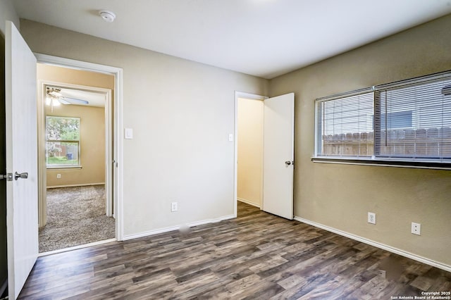unfurnished bedroom with baseboards and wood finished floors