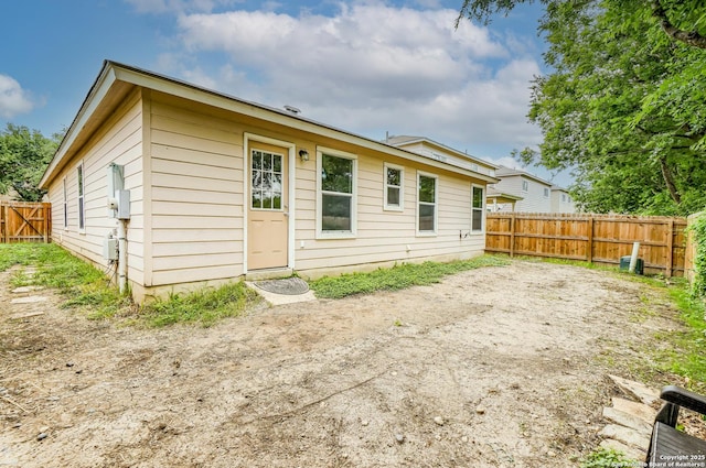 rear view of property featuring a fenced backyard