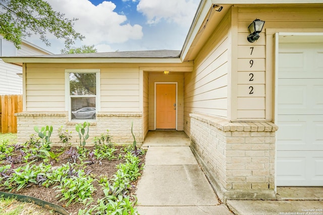 view of exterior entry with fence