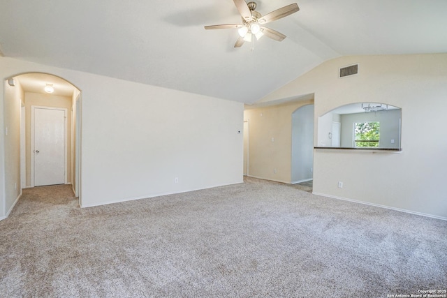 unfurnished living room with a ceiling fan, arched walkways, visible vents, and vaulted ceiling