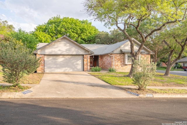 single story home with a garage, driveway, and brick siding