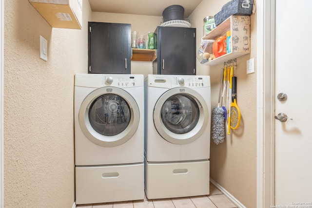 clothes washing area featuring light tile patterned floors, baseboards, laundry area, and independent washer and dryer