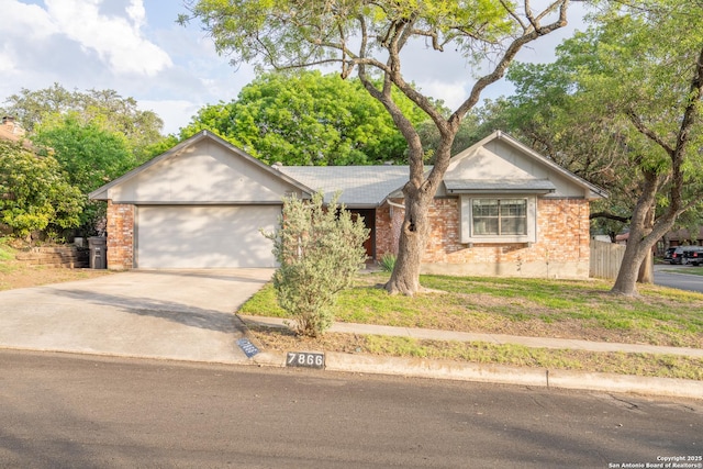 single story home with concrete driveway, brick siding, and an attached garage