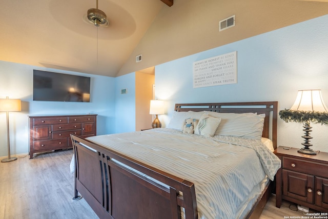bedroom featuring visible vents, beamed ceiling, high vaulted ceiling, a ceiling fan, and light wood-style flooring