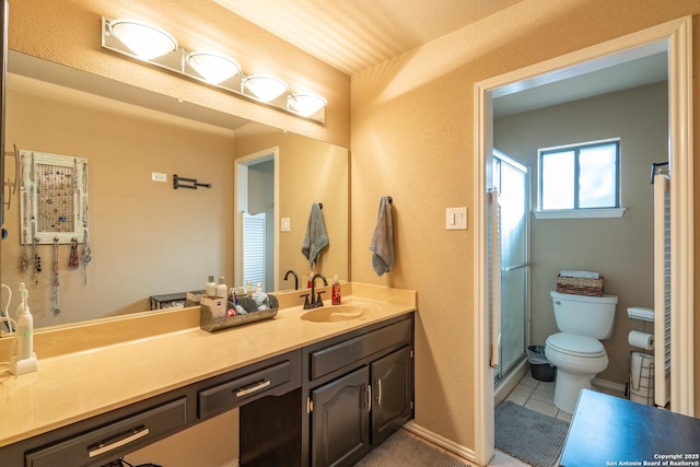 bathroom featuring vanity, tile patterned flooring, toilet, and a shower stall