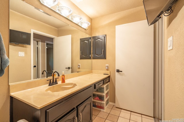 bathroom featuring tile patterned flooring and vanity
