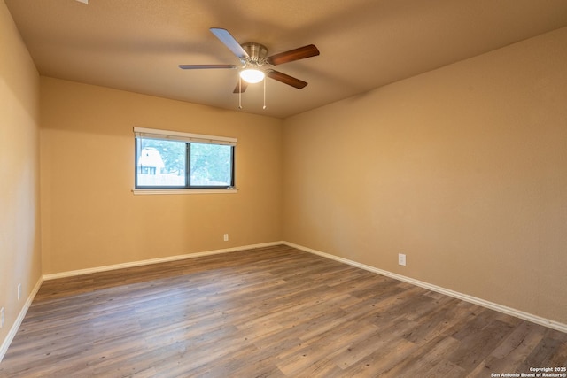 unfurnished room with baseboards, a ceiling fan, and wood finished floors