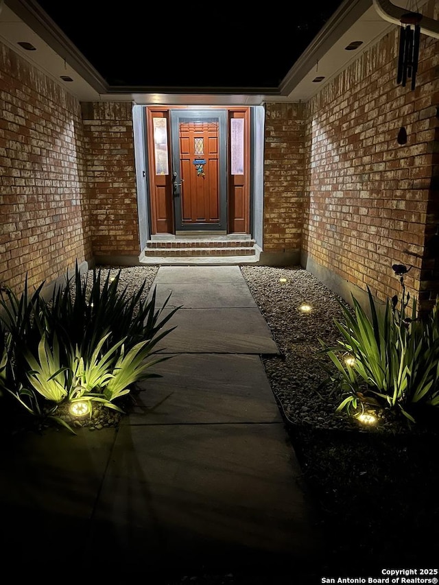 entrance to property with brick siding