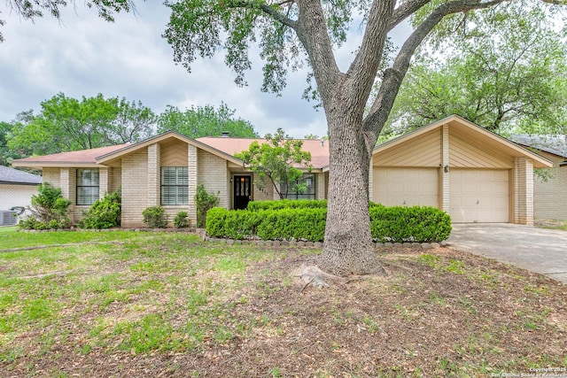 15111 Elkton, San Antonio, TX 78232 - ranch-style home with concrete driveway, brick siding, an attached garage, and central air condition unit