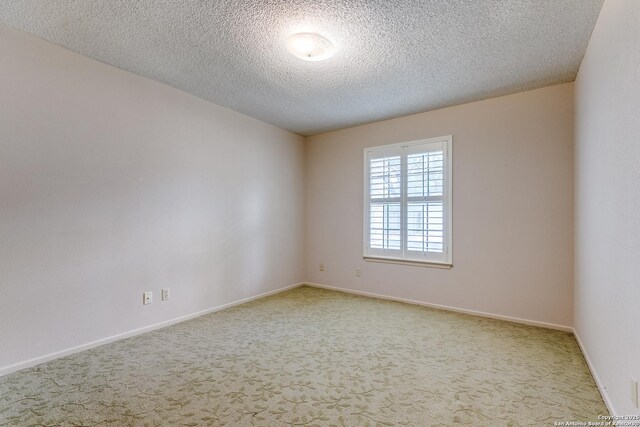 15111 Elkton, San Antonio, TX 78232 - empty room with baseboards, carpet flooring, and a textured ceiling