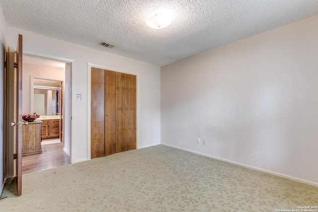 15111 Elkton, San Antonio, TX 78232 - unfurnished bedroom featuring carpet floors, a textured ceiling, baseboards, visible vents, and a closet