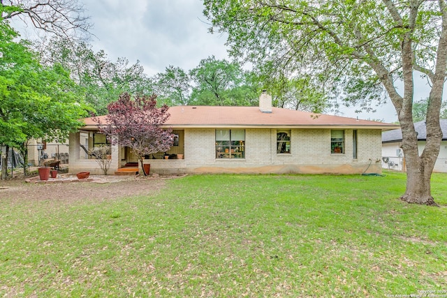 15111 Elkton, San Antonio, TX 78232 - rear view of house featuring a yard, brick siding, fence, and a chimney