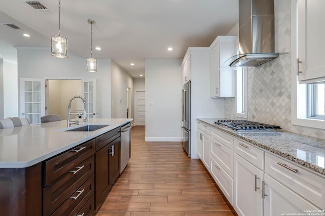 8314 Marek, San Antonio, TX 78224 - kitchen with stainless steel appliances, visible vents, wall chimney exhaust hood, and dark brown cabinets